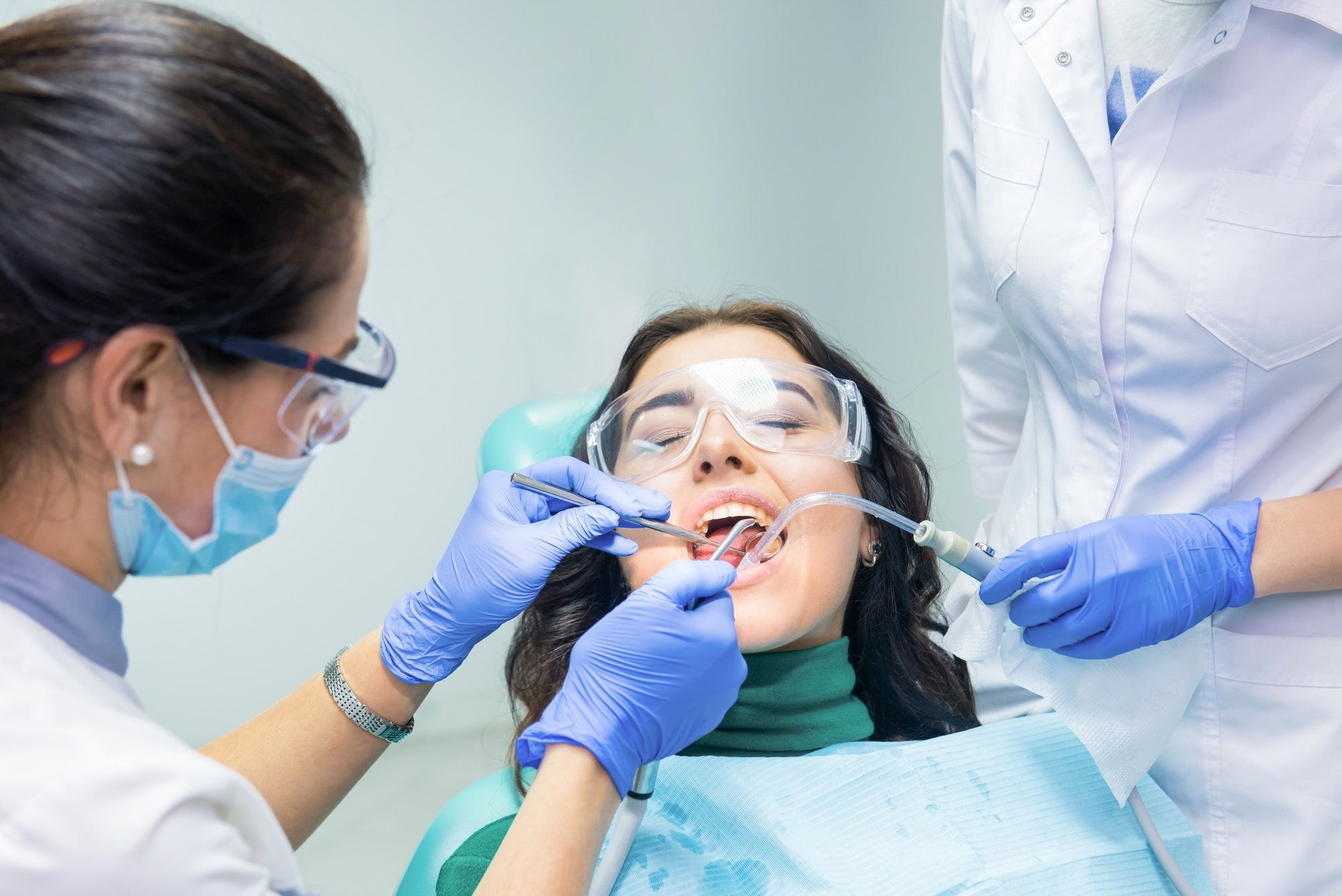 two-dentists-working-with-patient.jpg